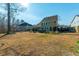 Wide shot of a spacious, unfenced backyard featuring a swing set, patio, and a two-story home at 136 Stagecoach Ln, Summerville, SC 29483