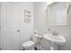 Bathroom with pedestal sink, toilet, and decorative mirror at 136 Stagecoach Ln, Summerville, SC 29483