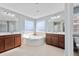Bathroom featuring double vanities, a tiled floor, a garden tub, and large windows at 136 Stagecoach Ln, Summerville, SC 29483