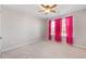 Cozy bedroom features plush carpeting, a ceiling fan, and lots of natural light from a large window at 136 Stagecoach Ln, Summerville, SC 29483