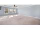 Spacious primary bedroom with carpet, light-blue walls, three large windows and a ceiling fan at 136 Stagecoach Ln, Summerville, SC 29483