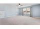 Spacious bedroom featuring modern ceiling fan, a window, shelving, and a neutral carpet at 136 Stagecoach Ln, Summerville, SC 29483