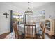 Dining room with chandelier, table setting, and sliding doors to screened-in porch at 136 Stagecoach Ln, Summerville, SC 29483