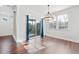 Dining room with hardwood floors, large windows, and slider door to screened-in porch at 136 Stagecoach Ln, Summerville, SC 29483