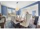 Dining room with seating for eight, elegant chandelier, and blue accent wall at 136 Stagecoach Ln, Summerville, SC 29483