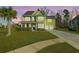 Charming two-story home features a manicured lawn, attached two-car garage, and a beautiful palm tree in the front yard at 136 Stagecoach Ln, Summerville, SC 29483