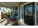 Inviting covered front porch with rocking chairs and a stylish front door with decorative glass detailing at 136 Stagecoach Ln, Summerville, SC 29483