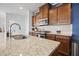 Close up on granite countertop island with stainless steel sink and stainless appliances at 136 Stagecoach Ln, Summerville, SC 29483