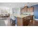 Open kitchen featuring a large island with granite countertops, seating, and wood floors at 136 Stagecoach Ln, Summerville, SC 29483