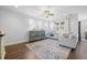Bright living room with a ceiling fan, a gray accent cabinet, and a white sofa at 136 Stagecoach Ln, Summerville, SC 29483