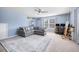 Inviting living room with ceiling fan, large rug, cozy seating, shelving and natural light at 136 Stagecoach Ln, Summerville, SC 29483