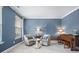 A blue living room featuring two armchairs, a table, and a piano at 136 Stagecoach Ln, Summerville, SC 29483