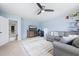 Comfortable living room area with ceiling fan, large rug, TV, shelving and cozy seating at 136 Stagecoach Ln, Summerville, SC 29483