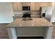 This kitchen island features a granite countertop, stainless steel sink, and ample storage space at 137 Haventree Ct, Summerville, SC 29486