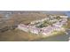 An aerial view of waterway condos featuring a pool, tennis courts, ample parking, and waterfront access at 138 W Mariners Cay Dr, Folly Beach, SC 29439