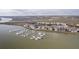 Aerial view of waterfront condominiums with marina and dock access offering beautiful waterfront views and coastal living at 138 W Mariners Cay Dr, Folly Beach, SC 29439