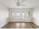 Bedroom with light hardwood floors and sliding glass doors to a balcony with water views at 138 W Mariners Cay Dr, Folly Beach, SC 29439