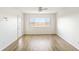 Bright bedroom with light hardwood floors, and a large window with marsh views at 138 W Mariners Cay Dr, Folly Beach, SC 29439