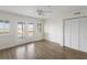 Bright bedroom with wood floors, a ceiling fan, a door to a private balcony and a closet at 138 W Mariners Cay Dr, Folly Beach, SC 29439