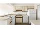 Kitchen with white appliances, cabinets, and a double sink with nice countertops at 138 W Mariners Cay Dr, Folly Beach, SC 29439