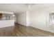 Open living room with light hardwood floors, access to a balcony, and a kitchen view at 138 W Mariners Cay Dr, Folly Beach, SC 29439