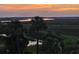 Sunset scene with palm trees overlooking the picturesque marsh and waterway at 138 W Mariners Cay Dr, Folly Beach, SC 29439
