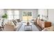 Cozy living room with modern décor, wood floors, and a sliding glass door that opens to the backyard at 139 Haventree Ct, Summerville, SC 29486