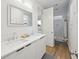 Bright bathroom featuring double sinks, hardwood floors, and access to a shower and tub at 14 F St # B, Charleston, SC 29403