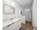 Bright bathroom featuring double sinks, hardwood floors, and access to a shower and tub at 14 F St # B, Charleston, SC 29403