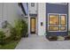 A modern front door with sleek glass, and landscaping on either side of the walkway at 14 F St # B, Charleston, SC 29403