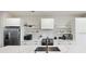 Contemporary kitchen with white cabinetry, a center island, open shelving, and modern appliances at 14 F St # B, Charleston, SC 29403