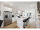 Bright, open kitchen featuring stainless steel appliances, an island with seating, and hardwood floors at 14 F St # B, Charleston, SC 29403