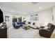 Cozy living room featuring hardwood floors, comfortable seating, and sliding glass door to backyard at 14 F St # B, Charleston, SC 29403