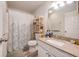 Well-lit bathroom featuring a granite vanity, mirror, and a shower with decorative shower curtain at 1402 Camp Rd # 9G, Charleston, SC 29412