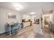 A bright dining area adjacent to the kitchen, featuring white cabinets, laminate flooring, and modern lighting at 1402 Camp Rd # 9G, Charleston, SC 29412
