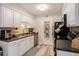 A bright kitchen featuring white cabinets, ample counter space, and modern stainless steel appliances at 1402 Camp Rd # 9G, Charleston, SC 29412