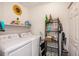 Functional laundry room with a washer, dryer, and shelving for storage and organization at 1402 Camp Rd # 9G, Charleston, SC 29412