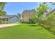 Spacious backyard with lush green grass and mature trees, perfect for outdoor activities at 1408 Bimini Dr, Charleston, SC 29414