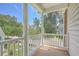 Charming balcony with white railing, offering a lovely view of the surrounding neighborhood at 1408 Bimini Dr, Charleston, SC 29414