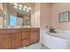 Bathroom featuring tub and shower, peach-colored walls, and a wood vanity at 1408 Bimini Dr, Charleston, SC 29414