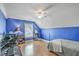 Bright bedroom featuring blue walls, wooden floors, and a white ceiling fan at 1408 Bimini Dr, Charleston, SC 29414