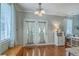 Dining area with french doors, window with blinds, hardwood floors, and modern decor at 1408 Bimini Dr, Charleston, SC 29414