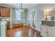Bright dining area features hardwood floors, updated light fixture, and french doors to the outside at 1408 Bimini Dr, Charleston, SC 29414