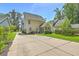 Back exterior view showcasing a well-maintained yard with a long driveway at 1408 Bimini Dr, Charleston, SC 29414