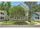 Charming two-story home with a well-manicured lawn and a beautiful front yard tree at 1408 Bimini Dr, Charleston, SC 29414
