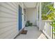 Inviting front porch features a blue door, white railings, and potted plants at 1408 Bimini Dr, Charleston, SC 29414