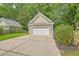 Detached garage with a white door and a concrete driveway surrounded by trees at 1408 Bimini Dr, Charleston, SC 29414