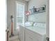 Laundry room with updated washer, dryer, shelving and natural light at 1408 Bimini Dr, Charleston, SC 29414