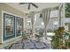 Comfortable screened-in porch with wicker chairs, plants, and an outdoor view at 1408 Bimini Dr, Charleston, SC 29414