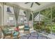 Relaxing sunroom with wicker furniture and a patterned rug, overlooking the backyard at 1408 Bimini Dr, Charleston, SC 29414